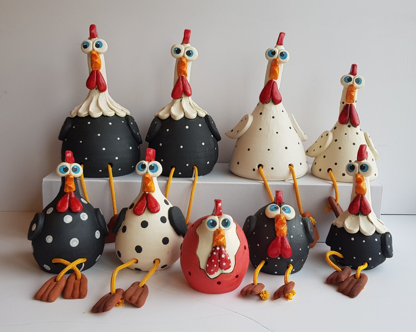 Two black and white handmade ceramic chickens