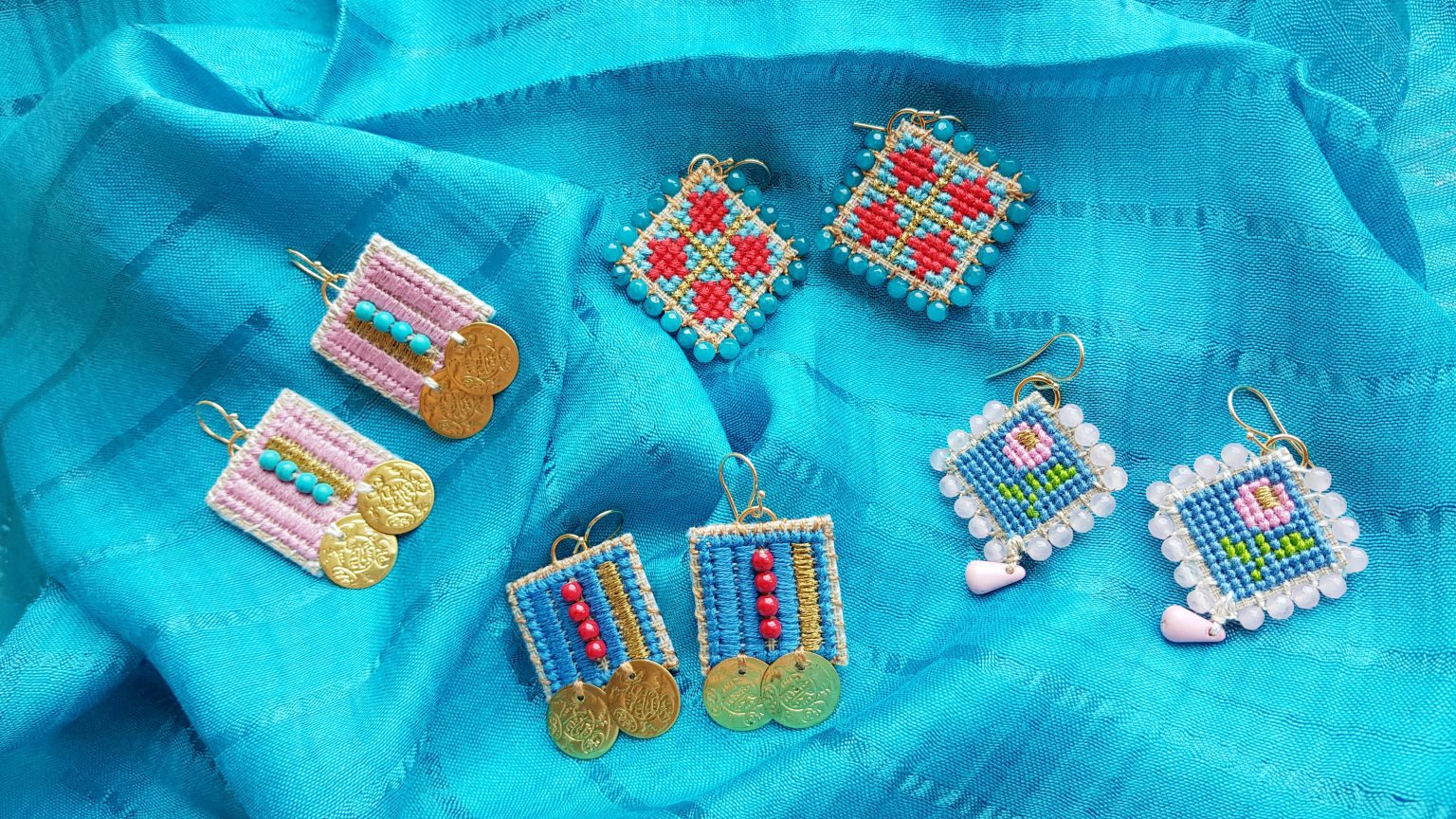 Blue hand-stitched earrings with red "chaolites" & coins