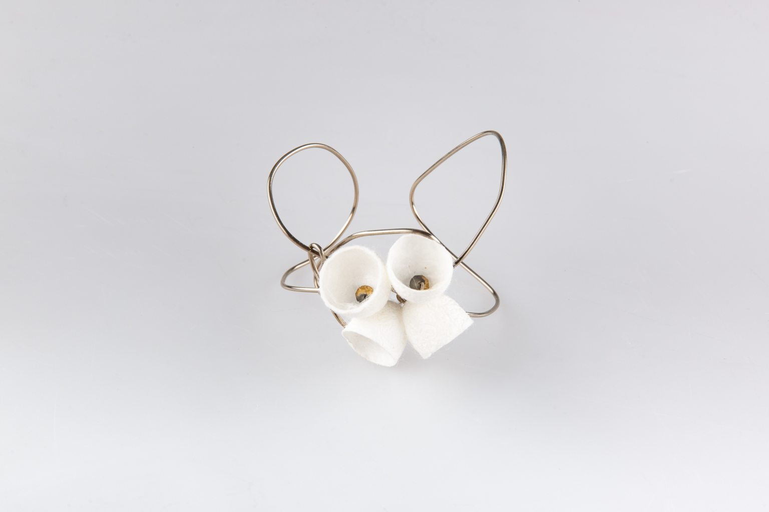 Cuff bracelet with white silk bells