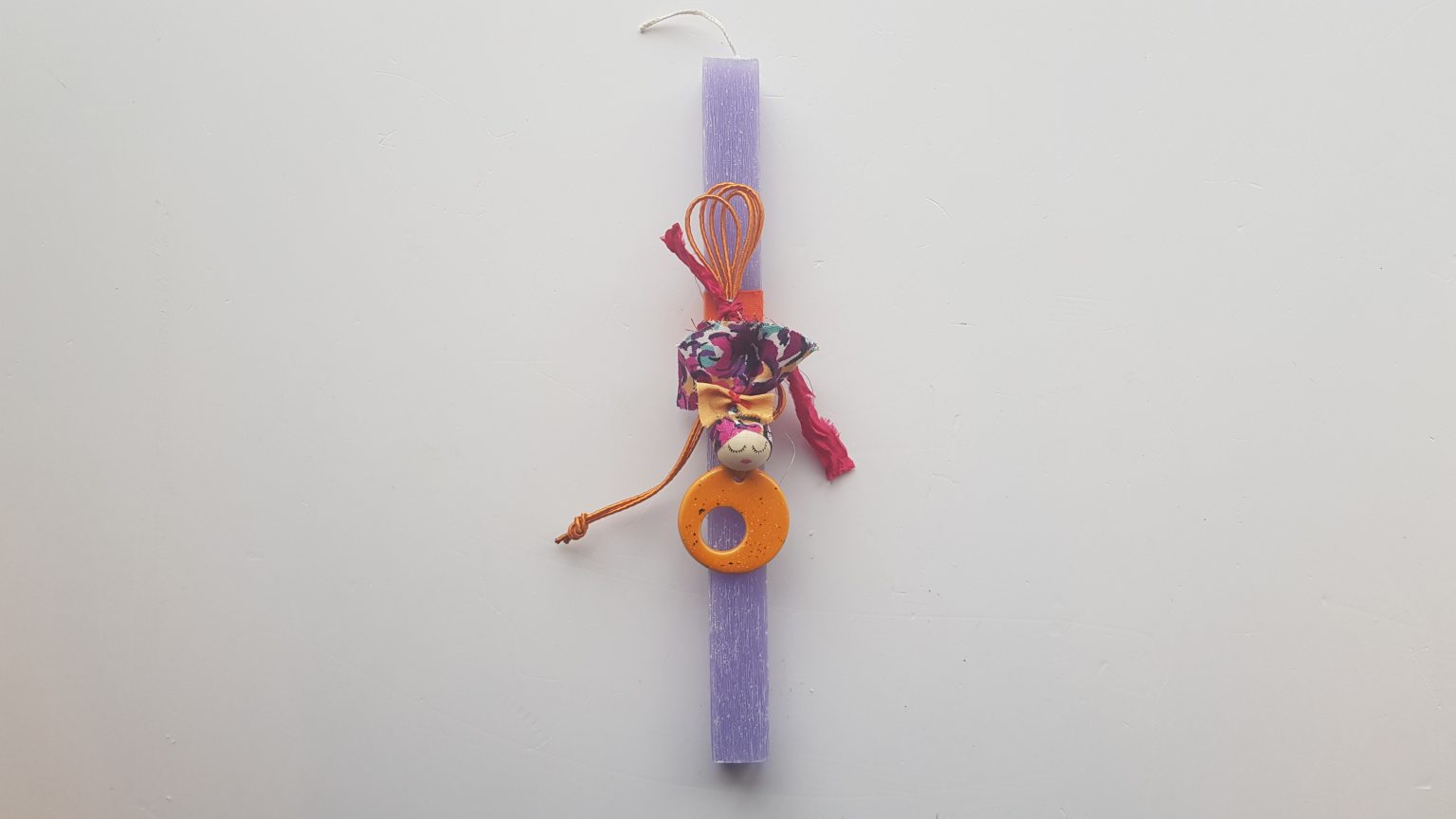 Handmade purple candle with orange pendant