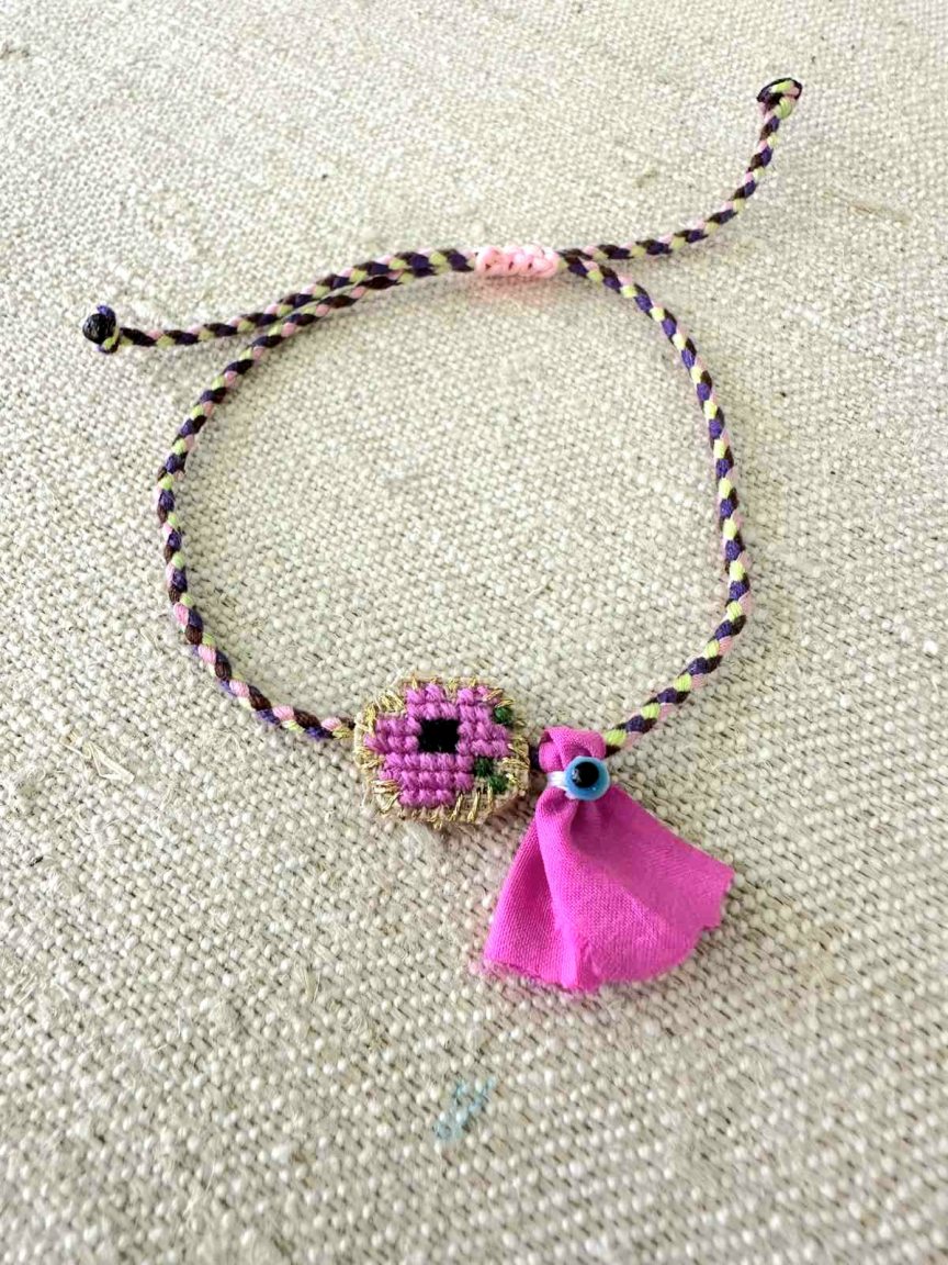 Embroidered bracelet with fuchsia flower