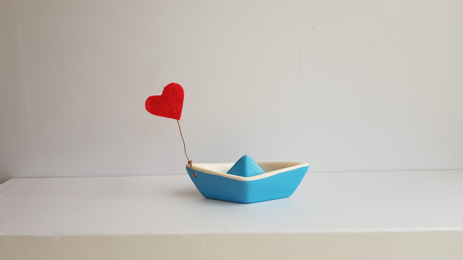 Small turquoise boat with heart