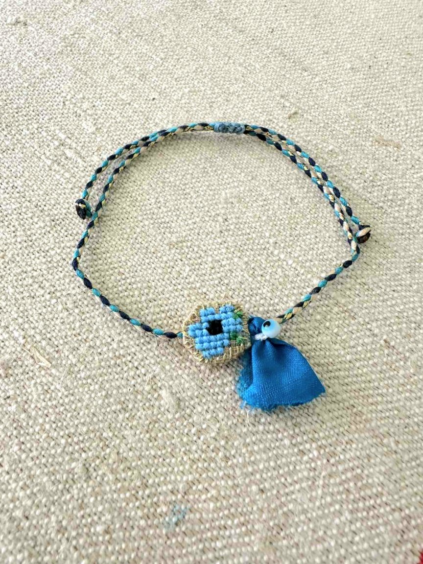 Embroidered bracelet with blue flower