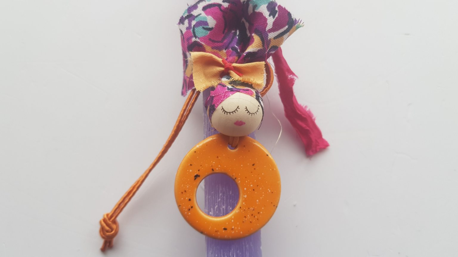 Handmade purple candle with orange pendant