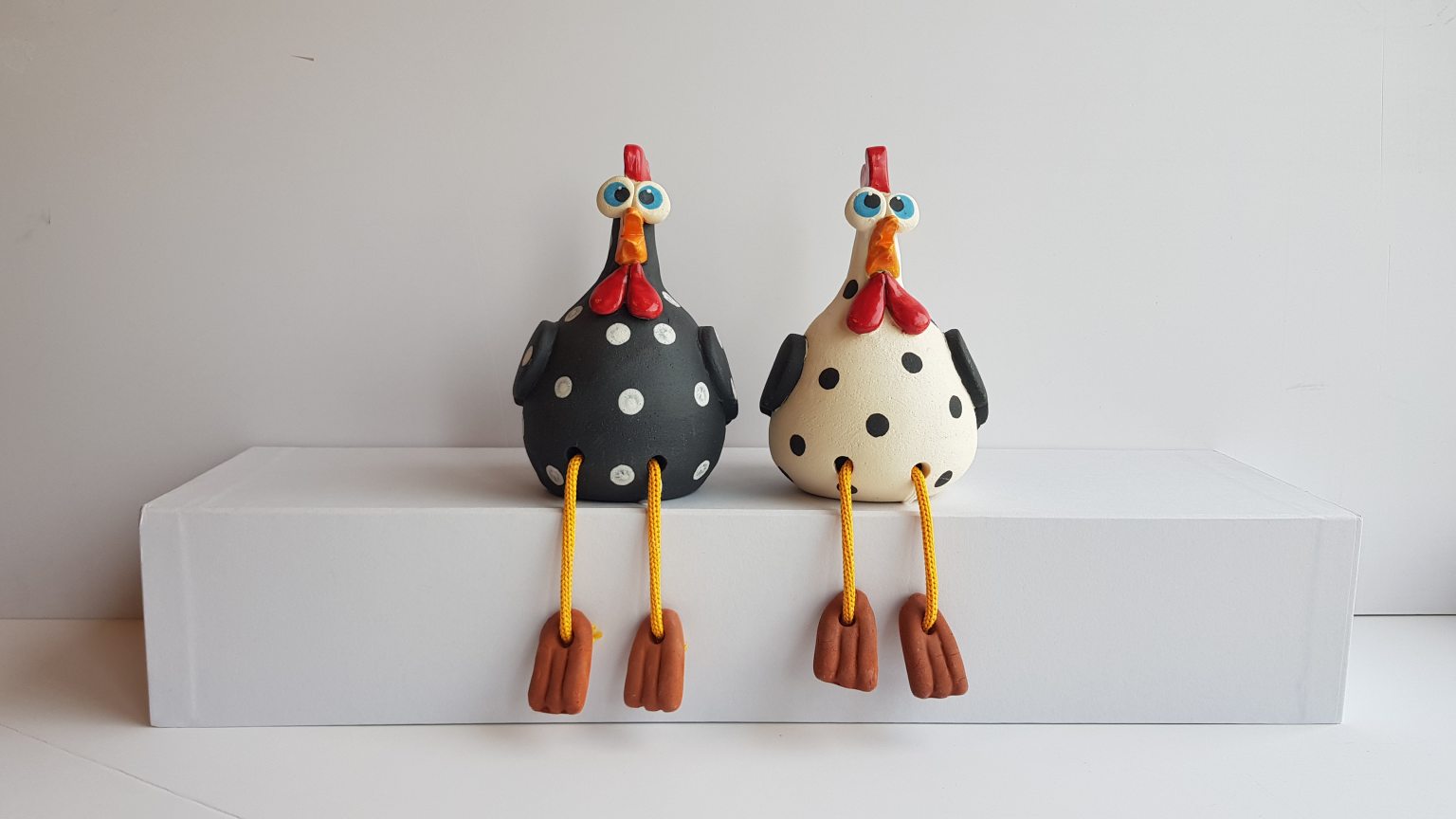 Two black and white handmade ceramic chickens