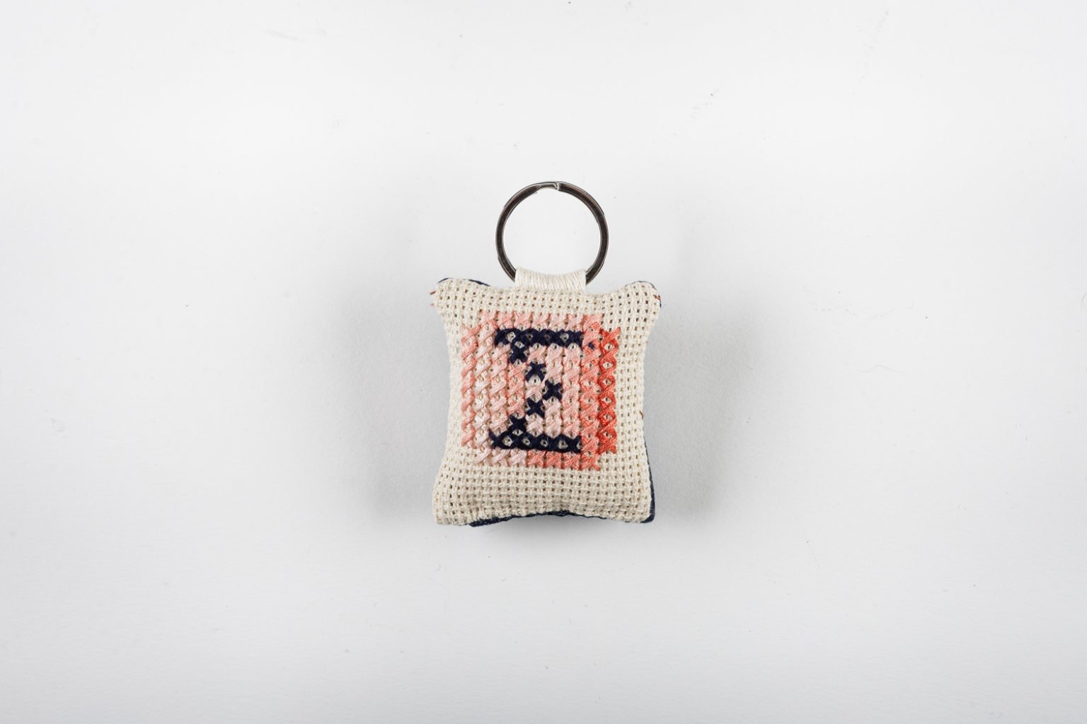 Hand-embroidered keyring with initial "Σ"