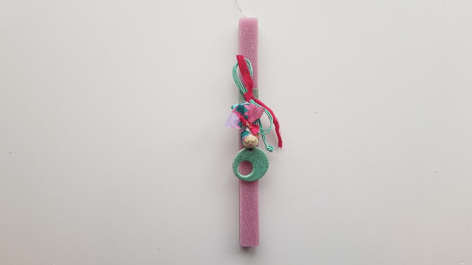 Handmade pink candle with turquoise pendant