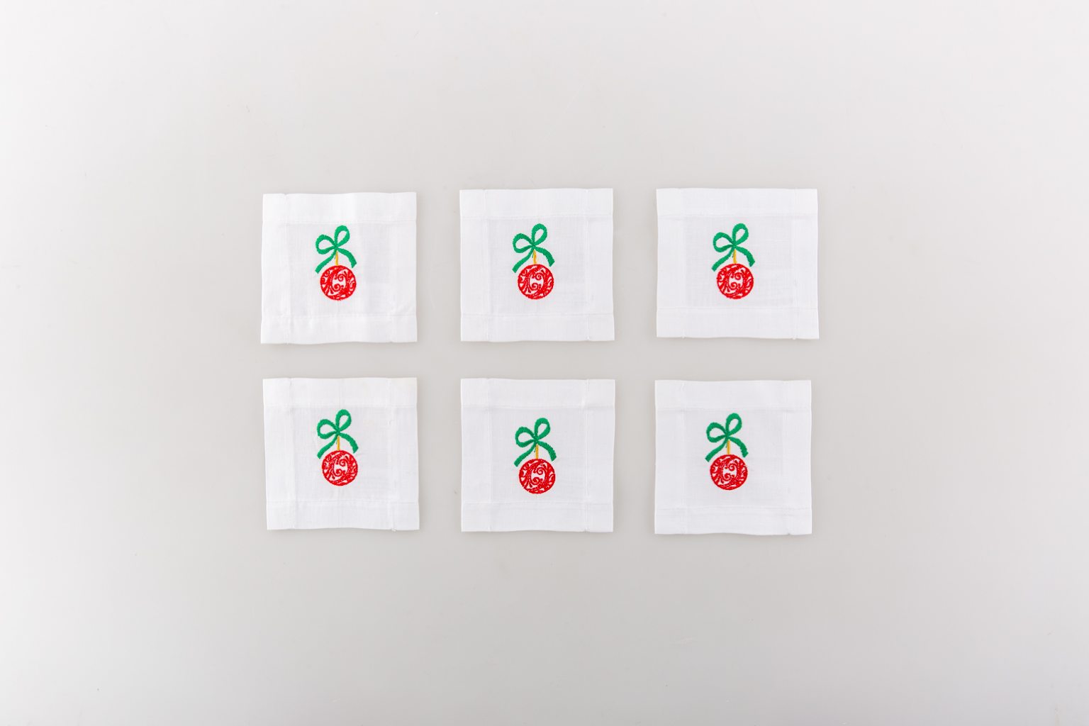 Set of six coasters with red tree ornament 