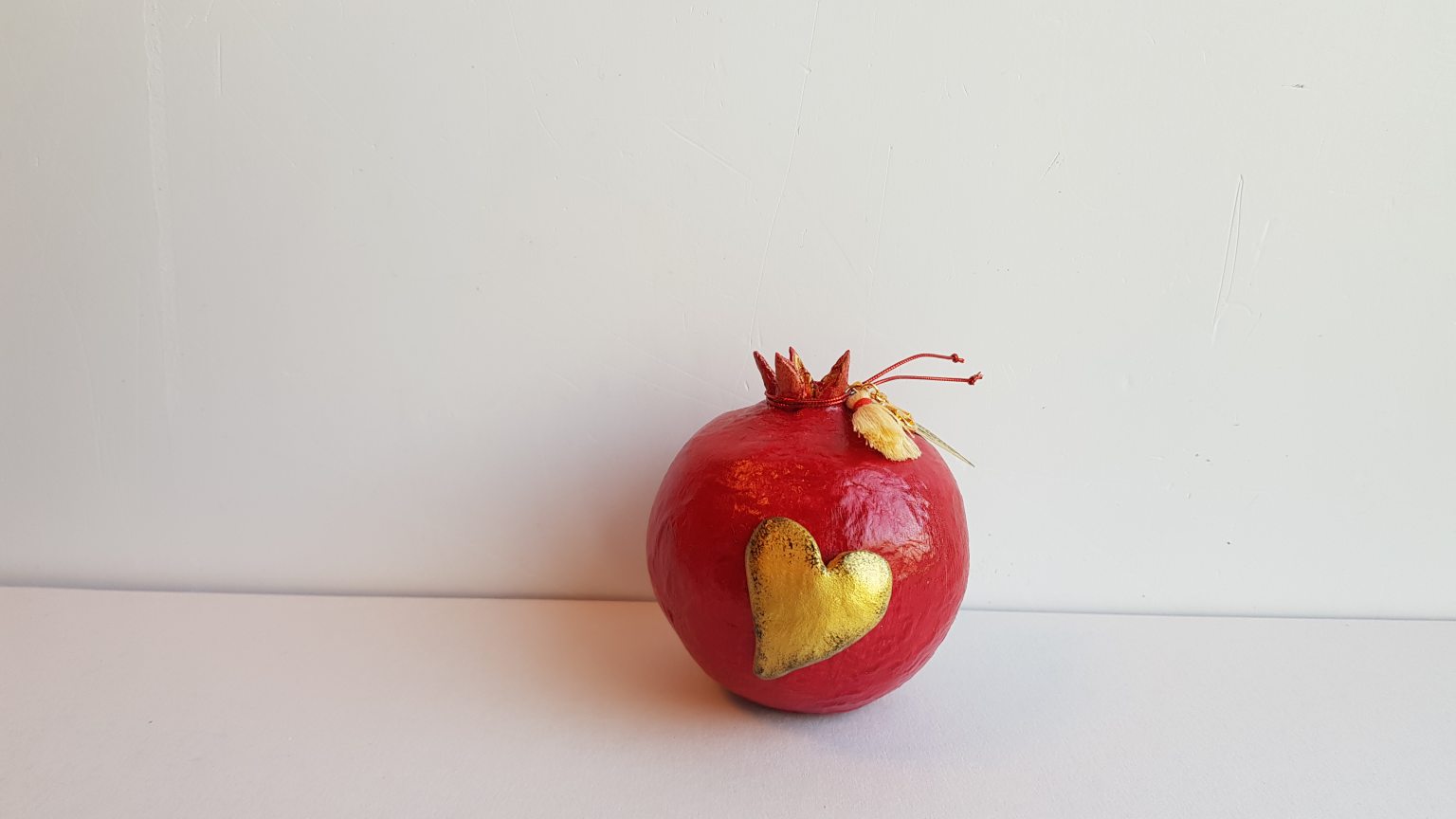 Red pomegranate made of papier-mâché 