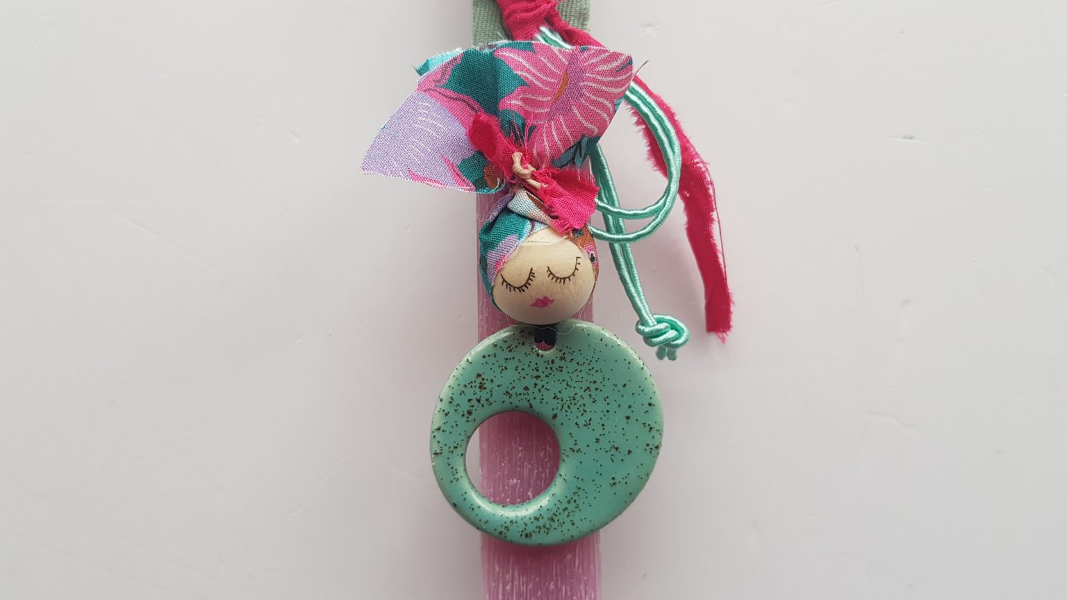 Handmade pink candle with turquoise pendant