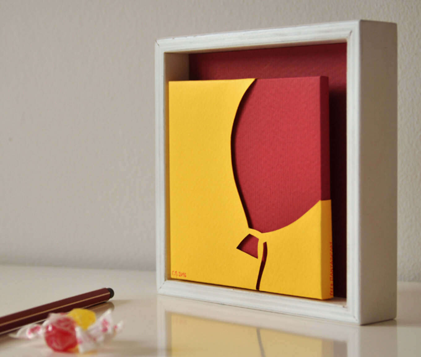 Wall frame with red ballon
