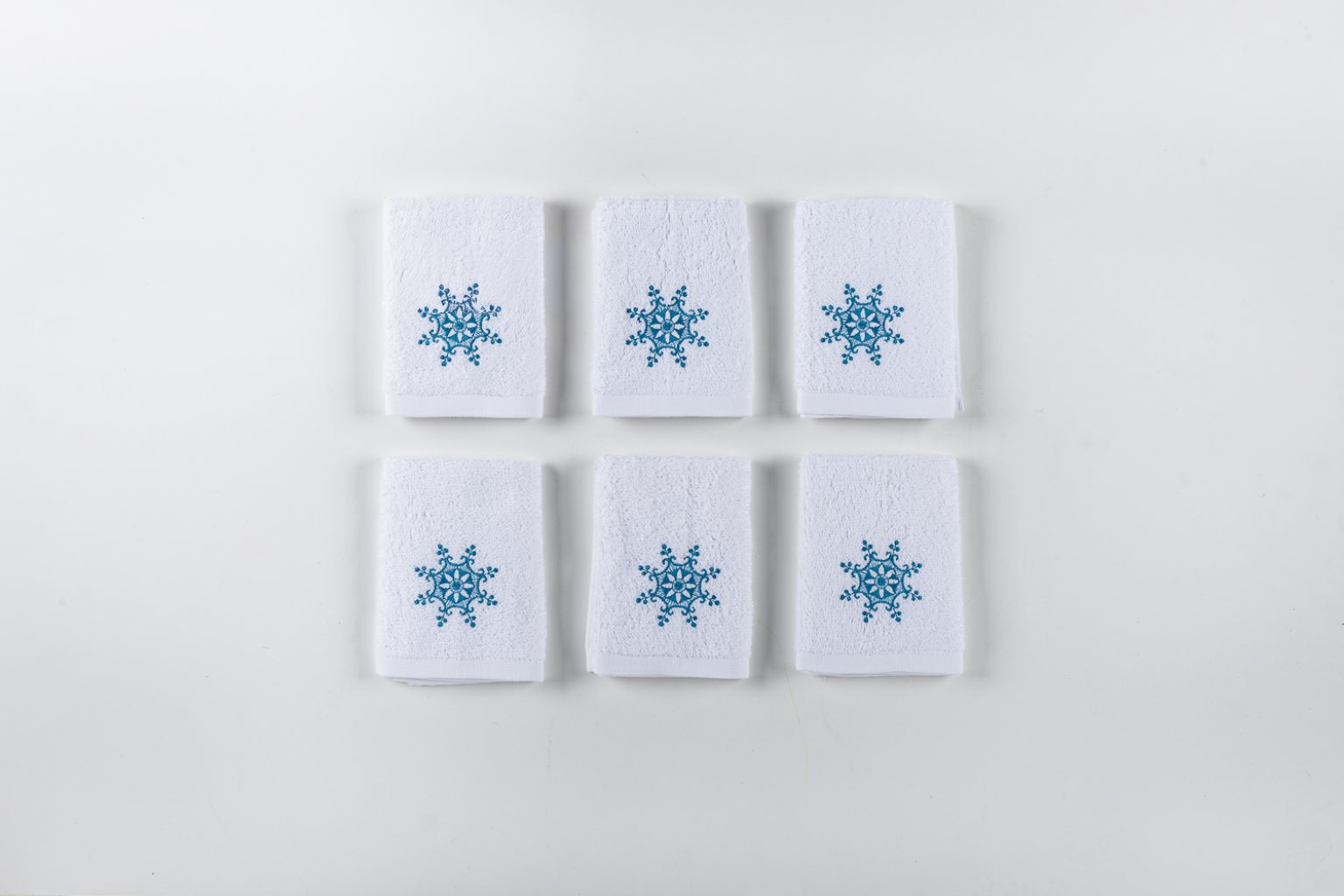 Set of six snowflake bath towels